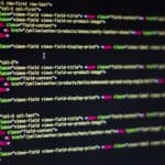 Developer writing code on a laptop