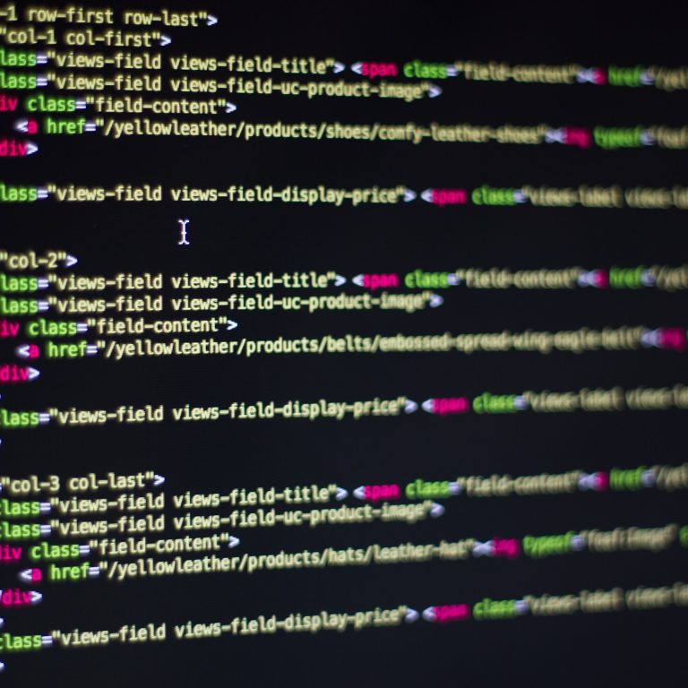 Developer writing code on a laptop